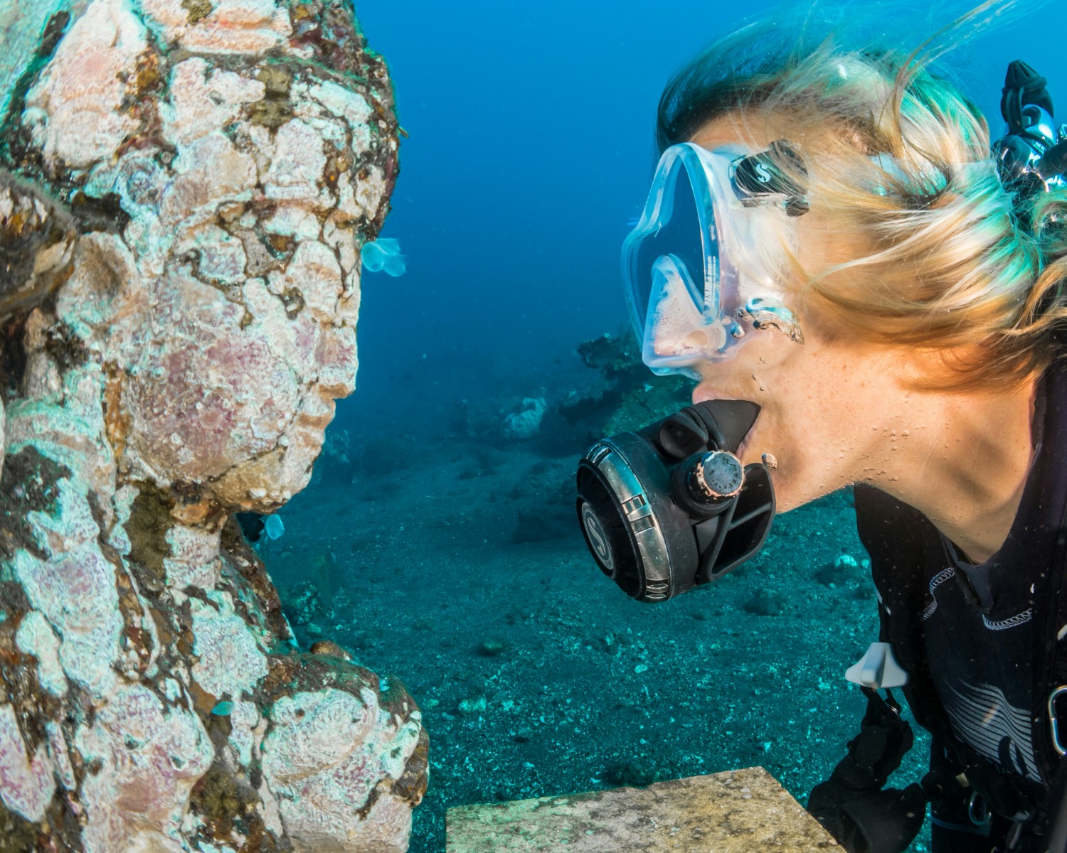 Scuba diving group exploring underwater formations