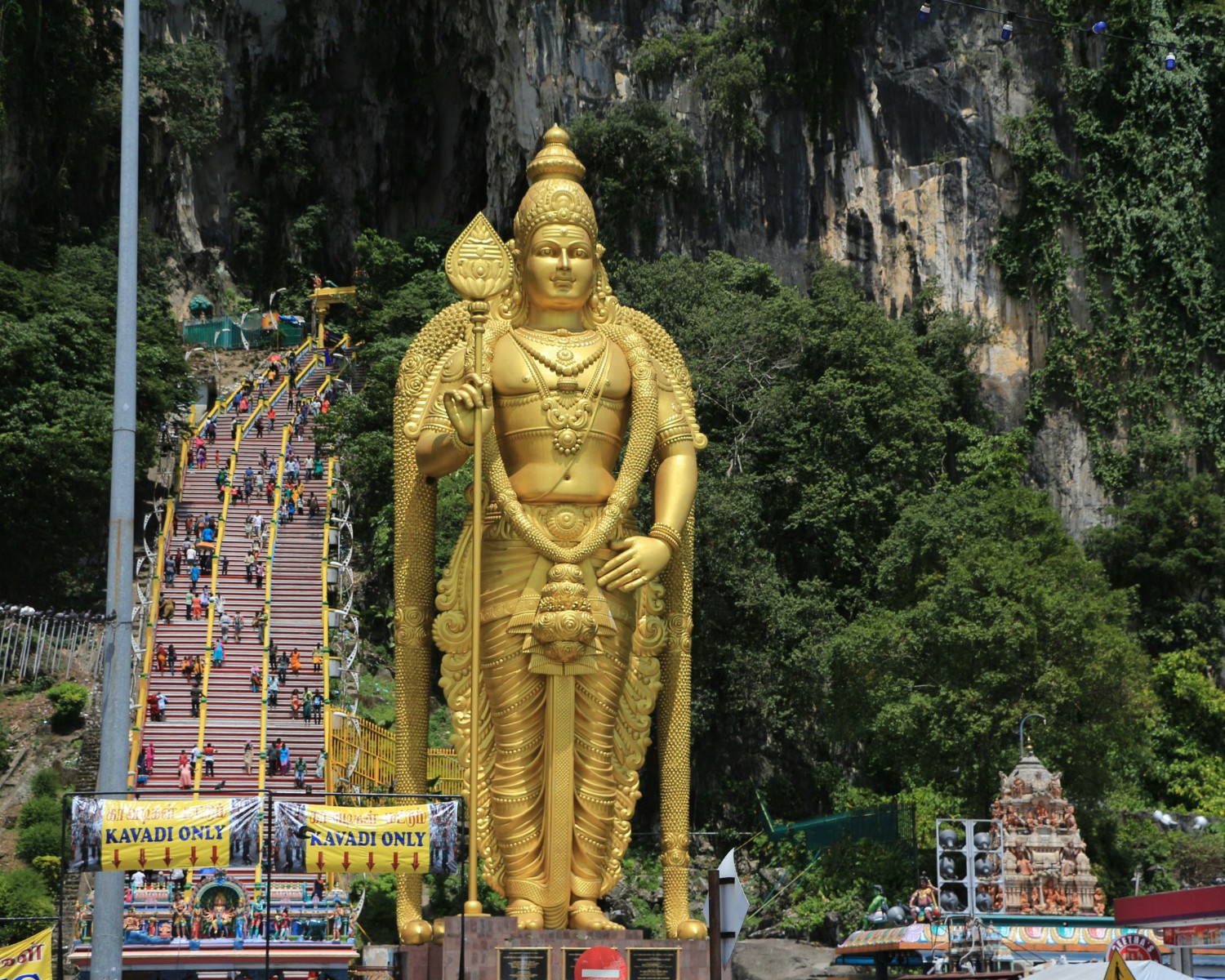 Batu Caves golden statue and colorful rainbow steps