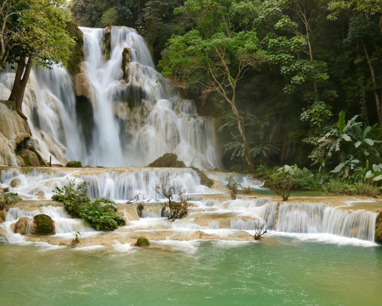 Kuang Si's turquoise pools beneath cascading tiers