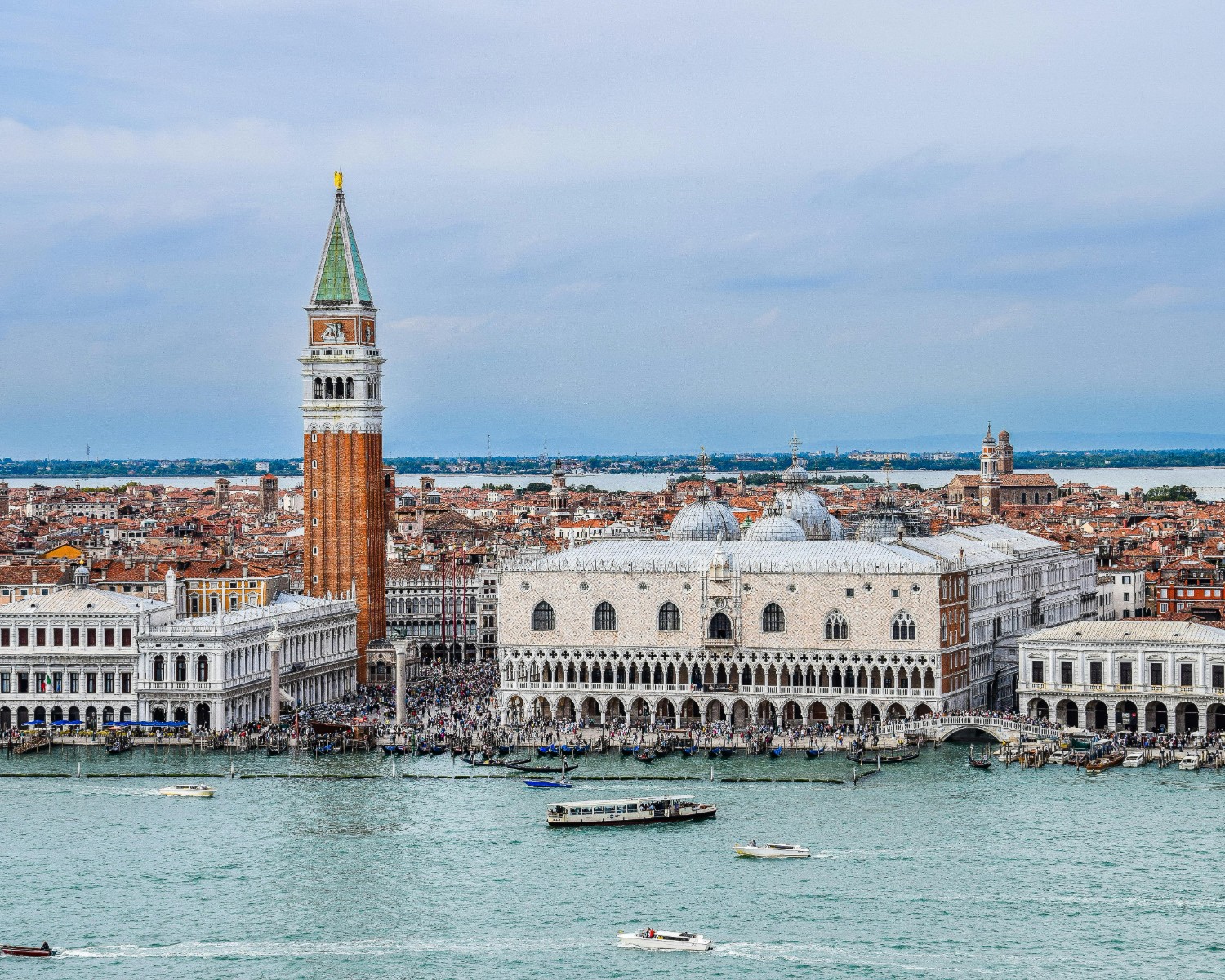 Venice's Grand Canal at sunset with gondolas and Renaissance palaces reflected