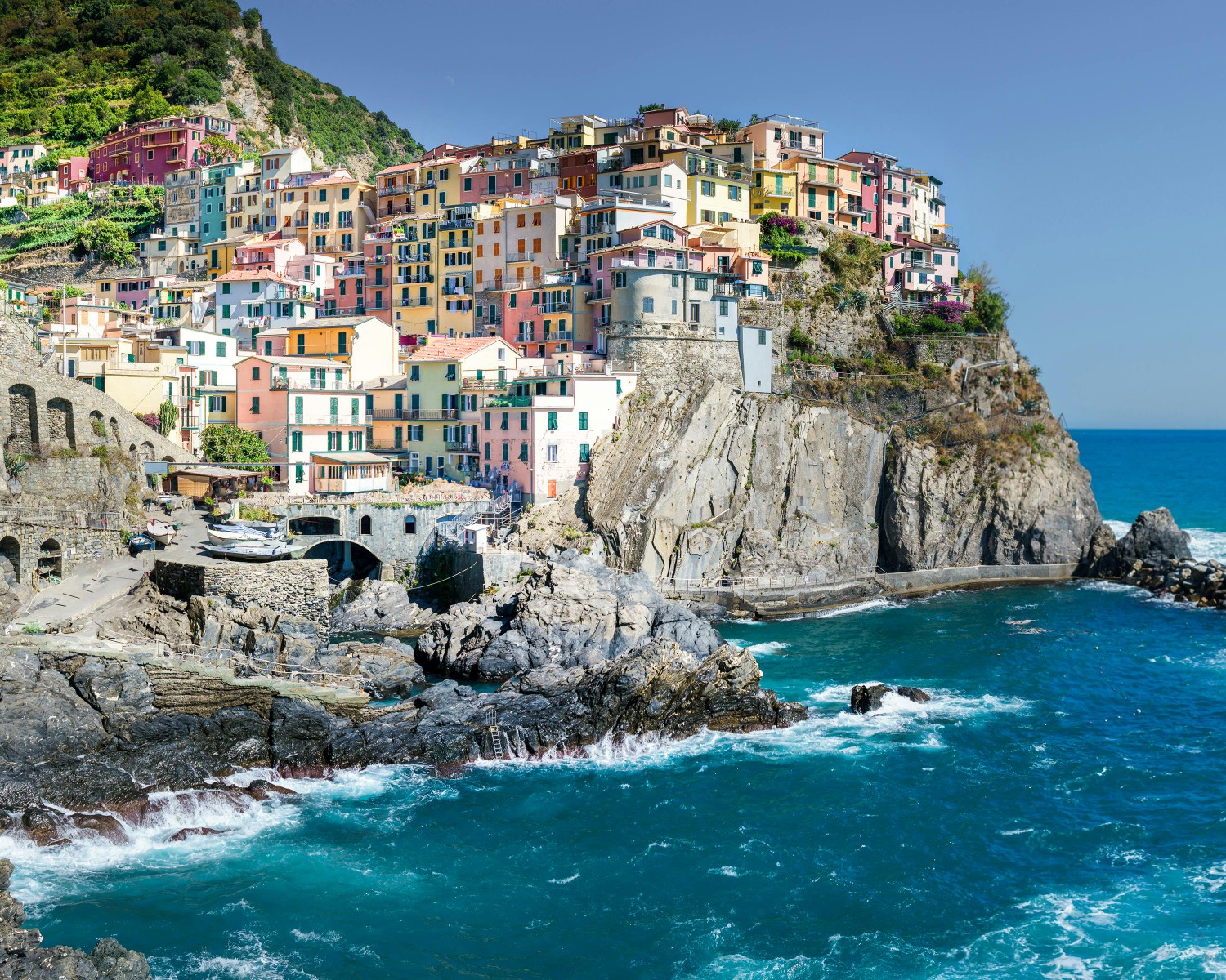 Positano's pastel-colored village cascading down cliffside to turquoise sea